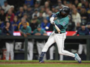 Seattle Mariners' J.P. Crawford hits a three-run double against the Houston Astros during the eighth inning of a baseball game Saturday, May 6, 2023, in Seattle.