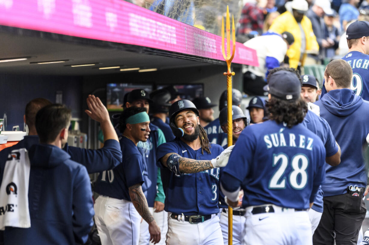 Seattle Mariners' J.P. Crawford (3) holds a trident after his two-run home run against the Oakland Athletics during the fifth inning of a baseball game Tuesday, May 23, 2023, in Seattle.