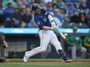 Seattle Mariners' Ty France hits a solo home run on a pitch from Oakland Athletics starting pitcher JP Sears during the first inning of a baseball game, Thursday, May 25, 2023, in Seattle.