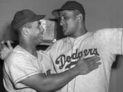 FILE - Brooklyn Dodgers catcher Roy Campanella, left, congratulates his battery mate, Don Newcombe, in the dressing room at the Polo Grounds in New York on Sept. 2, 1949. Holman Stadium in Nashua, N.H., is being recognized for hosting the country's first racially integrated baseball team, the Nashua Dodgers, in 1946. The club was a minor league league affiliate of the Dodgers, which included Hall of Famer Campanella and future Cy Young Award winner Newcombe.