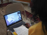 Calvernetta Williams, a long-time congregant of Zion Baptist Church, attends a virtual Sunday school class from her home in Columbia, S.C., on Sunday, April 16, 2023. Williams uses a hybrid model of attending church, Sunday school online, worship service in person, so that she can care for her husband who has Parkinson's.