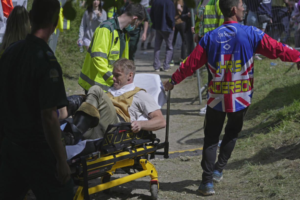 A participant receives medical treatment after the Cheese Rolling contest at Cooper's Hill in Brockworth, Gloucestershire, Monday May 29, 2023. The Cooper's Hill Cheese-Rolling and Wake is an annual event where participants race down the 200-yard (180 m) long hill chasing a wheel of double gloucester cheese.