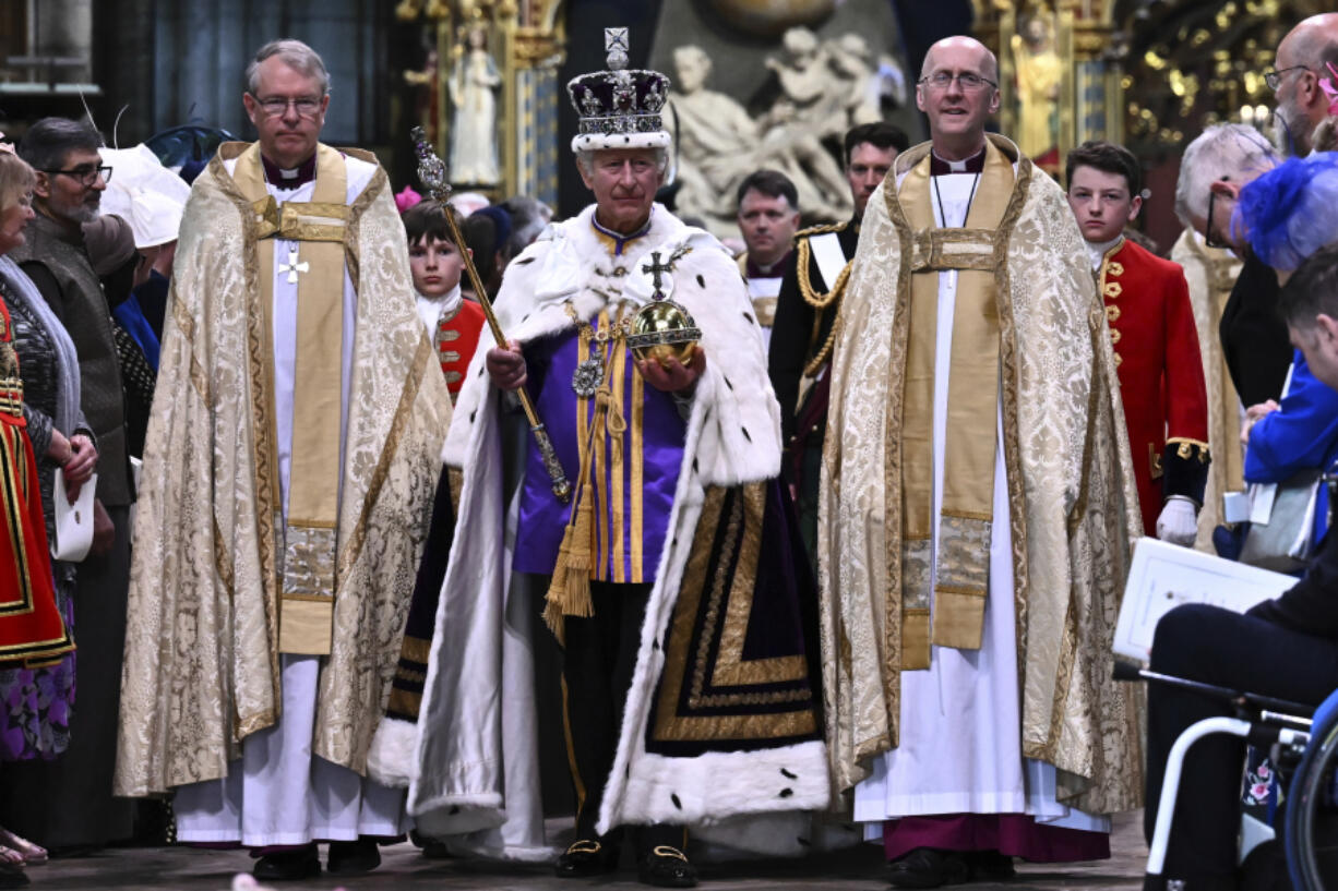Britain's King Charles III wearing the Imperial state Crown and carrying the Sovereign's Orb and Sceptre leaves Westminster Abbey after coronation in central London Saturday, May 6, 2023. The set-piece coronation is the first in Britain in 70 years, and only the second in history to be televised. Charles will be the 40th reigning monarch to be crowned at the central London church since King William I in 1066.
