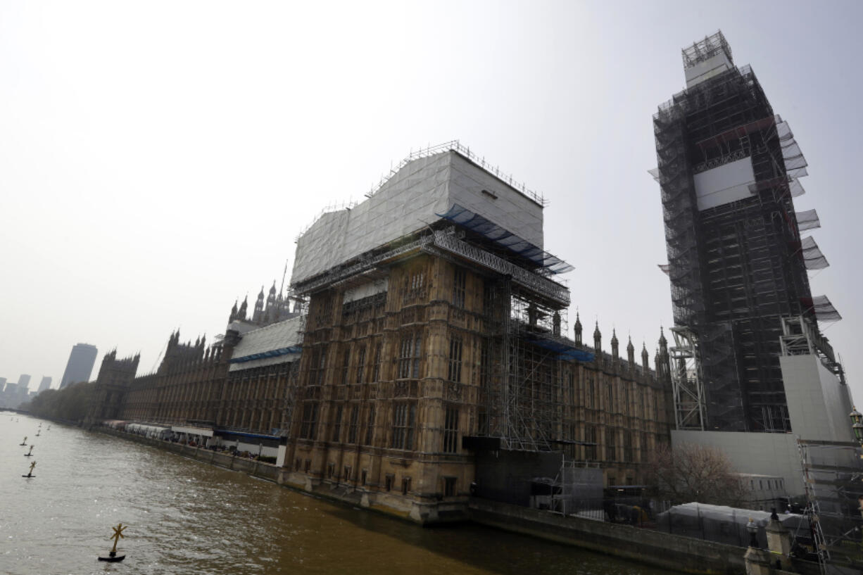 FILE - Britain's Houses of Parliament, covered in hoarding and scaffolding as it undergoes restoration work to repair the crumbling building, in London, Wednesday, April 17, 2019. British lawmakers are warning that the country's Parliament building is at "real and rising" risk of destruction. The House of Commons Public Accounts Committee said Parliament is "leaking, dropping masonry and at constant risk of fire," as well as riddled with asbestos.  The committee said Wednesday, May 17, 2023 that "there is a real and rising risk that a catastrophic event will destroy" the building before long-delayed restoration work is done.