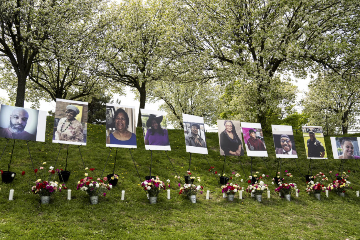 Flowers are placed near photographs of the victims killed in last year's racist massacre at a Buffalo supermarket as their lives are commemorated during the 5/14 Community Gathering for Reflection, Healing, and Hope at the Johnnie B. Wiley Amateur Athletic Sports Pavilion in Buffalo, N.Y. on Saturday, May 13, 2023.