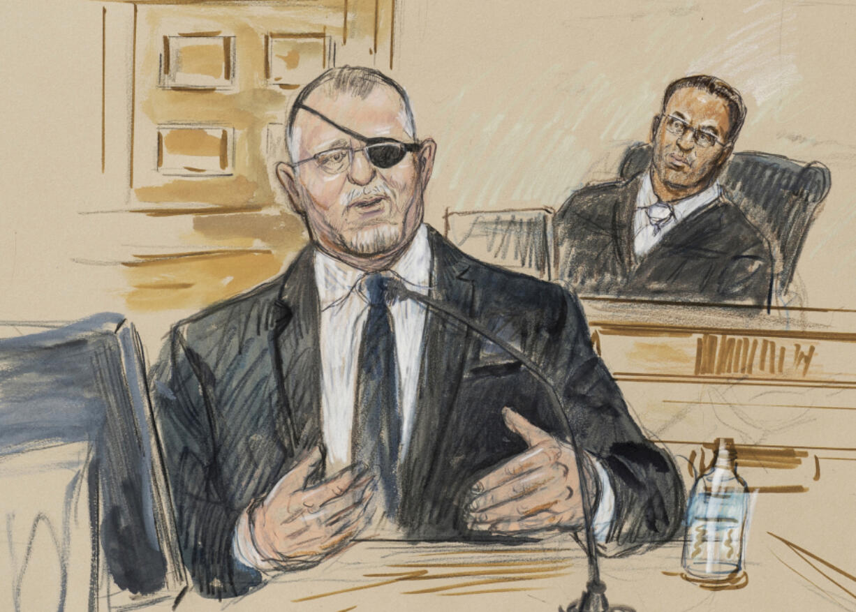 FILE - This artist sketch depicts the trial of Oath Keepers leader Stewart Rhodes, left, as he testifies before U.S. District Judge Amit Mehta on charges of seditious conspiracy in the Jan. 6, 2021, attack on the U.S. Capitol, in Washington, Nov. 7, 2022. Rhodes and members of his antigovernment group will be the first Jan. 6 defendants sentenced for seditious conspiracy in a series of hearings beginning this week that will set the standard for more punishments of far-right extremists to follow.