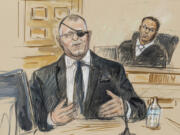 FILE - This artist sketch depicts the trial of Oath Keepers leader Stewart Rhodes, left, as he testifies before U.S. District Judge Amit Mehta on charges of seditious conspiracy in the Jan. 6, 2021, attack on the U.S. Capitol, in Washington, Nov. 7, 2022. Rhodes and members of his antigovernment group will be the first Jan. 6 defendants sentenced for seditious conspiracy in a series of hearings beginning this week that will set the standard for more punishments of far-right extremists to follow.