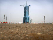 The Shenzhou-16 spacecraft sits atop a Long March rocket covered on a launch pad at the Jiuquan Satellite Launch Center in northwest China on Monday, May 29, 2023. China's space program plans to land astronauts on the moon before 2030, a top official with the country's space program said Monday.