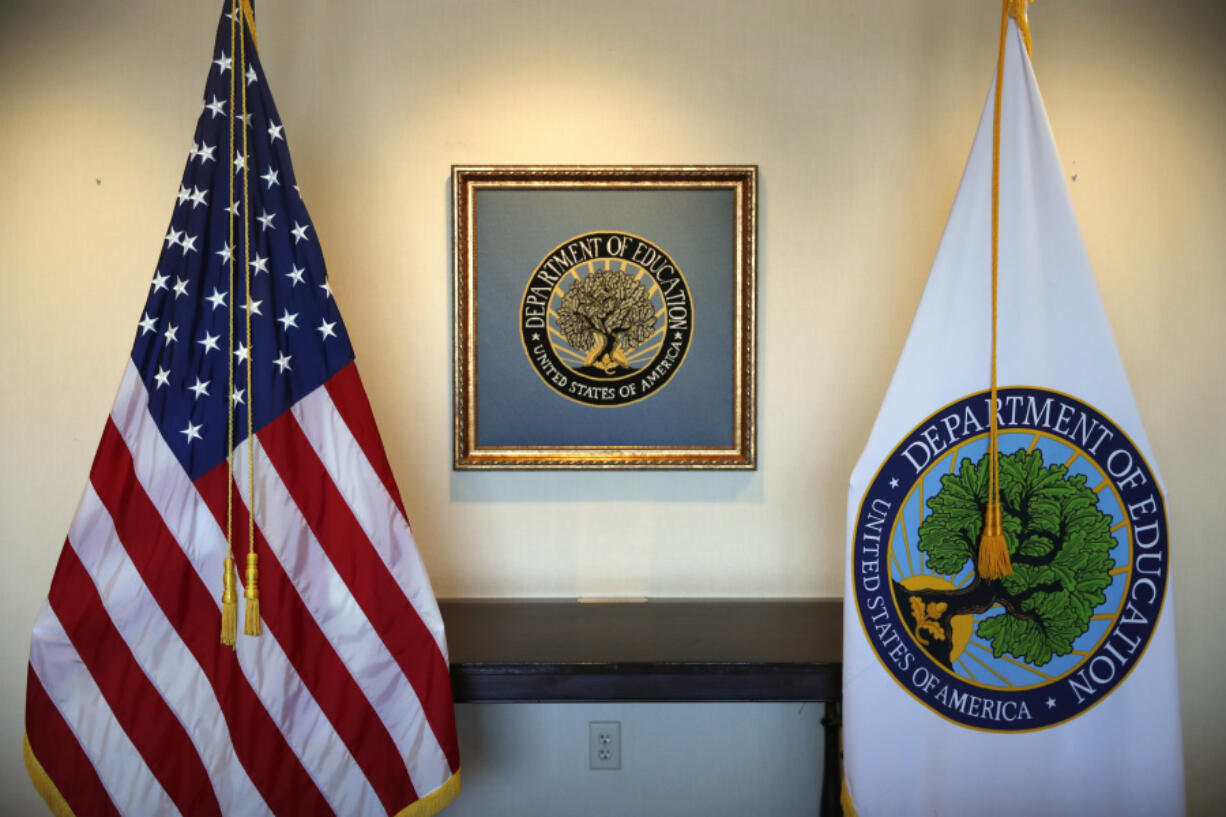 FILE - Flags decorate a space outside the office of the education secretary at the Education Department, Aug. 9, 2017, in Washington. College programs that leave graduates underpaid or buried in loans would be cut off from federal money under a proposal issued Wednesday, May 17, 2023, by the Biden administration, but the rules would apply only to for-profit colleges and a tiny fraction of programs at traditional universities.