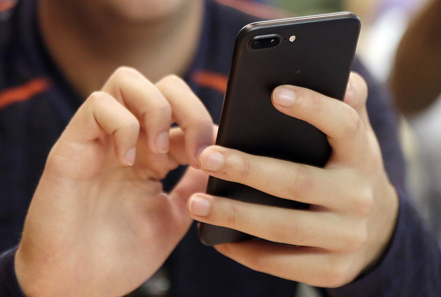 FILE - A person uses a smartphone in Chicago, Sept. 16, 2017. Most Democrats and Republicans agree that the federal government should better regulate the biggest technology companies, particularly social media platforms. But there is very little consensus on how it should be done.