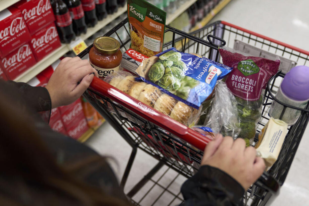 File - A cart holding groceries is pushed through a supermarket in Bellflower, Calif., on Monday, Feb. 13, 2023. On Wednesday, the Labor Department reports on U.S. consumer prices for April.