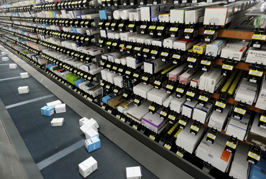 An automatic system drops pharmaceutical orders on a conveyor belt to be placed into boxes at Morris and Dickson Co., in Shreveport, Wednesday, July 13, 2016. The U.S. Drug Enforcement Administration has allowed one of the nation's largest wholesale drug distributors to keep shipping opioid painkillers for nearly four years after a judge recommended in 2018 it lose its license for its "cavalier disregard" of thousands of suspicious orders fueling the opioid crisis.