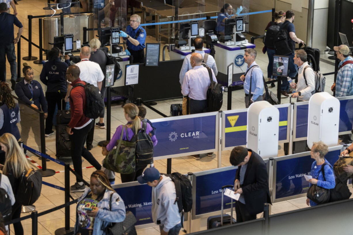 Travelers wait in line at a Baltimore-Washington International Thurgood Marshall Airport security checkpoint to use the Transportation Security Administration's new facial recognition, Wednesday, April 26, 2023, in Glen Burnie, Md.