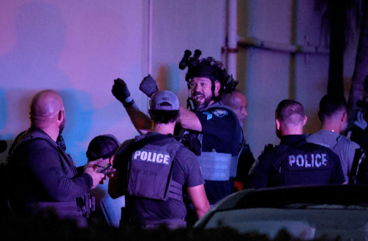 Police investigate a shooting on a beach boardwalk, Monday, May 29, 2023, in Hollywood, Fla.