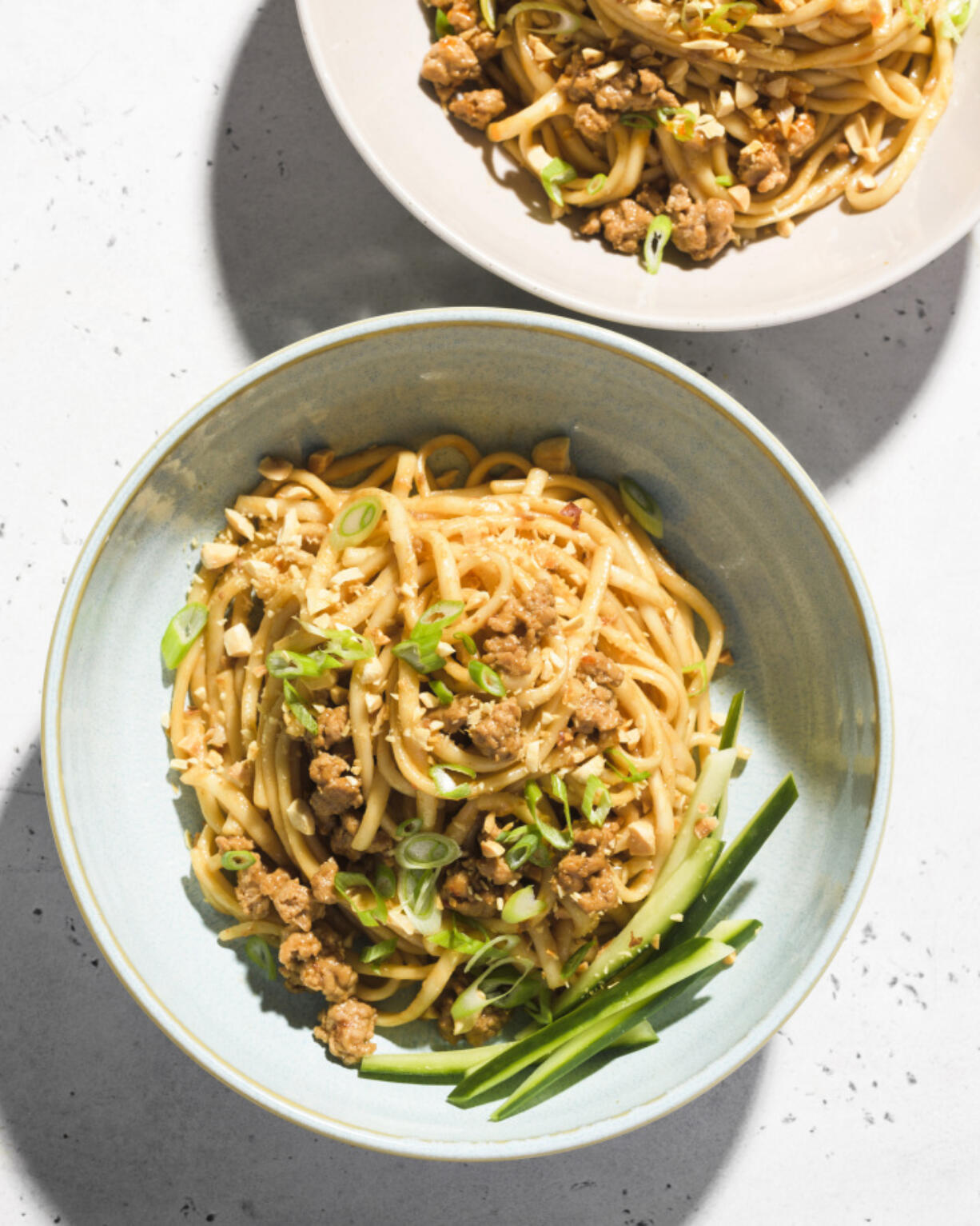 This image released by Milk Street shows a recipe for spicy pork and oyster sauce noodles.