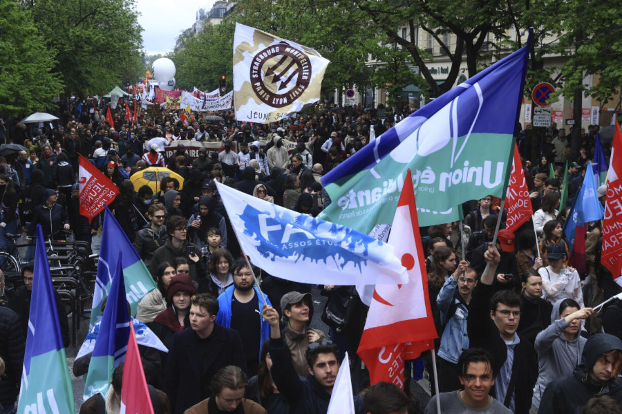 Protesters march during a demonstration, Monday, May 1, 2023 in Paris. Across France, thousands marched in what unions hope are the country's biggest May Day demonstrations in years, mobilized against President Emmanuel Macron's recent move to raise the retirement age from 62 to 64.