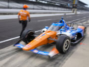 Scott Dixon, of New Zealand, drives out of the pit area during practice for the Indianapolis 500 auto race at Indianapolis Motor Speedway in Indianapolis, Friday, May 19, 2023.