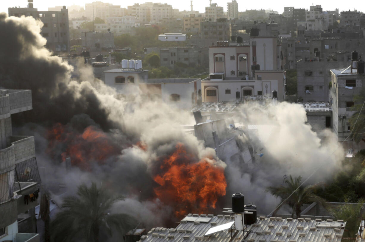 Smoke and fire rise from an explosion caused by an Israeli airstrike targeting a building in Gaza, Saturday, May 13, 2023. The building was owned by an Islamic Jihad official.