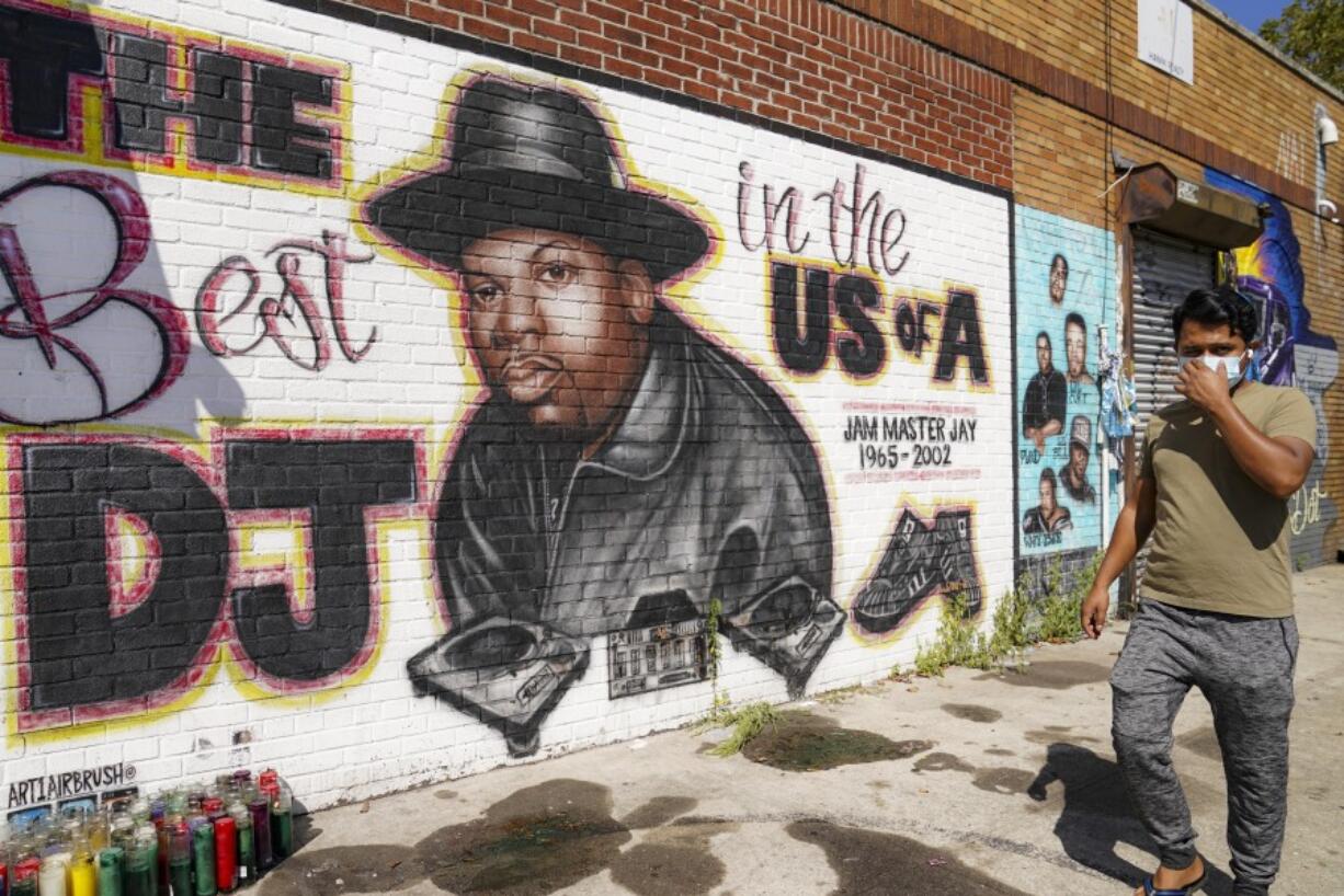FILE - A pedestrian passes a mural of rap pioneer Jam Master Jay of Run-DMC, by artist Art1Airbrush, Aug. 18, 2020, in the Queens borough of New York. A third man has been charged in the 2002 shooting death of hip-hop trailblazer Jam Master Jay, prosecutors said Tuesday, May 30, 2023, adding another suspect in the Run-DMC member's killing which for years after it initially happened had languished as a cold case.