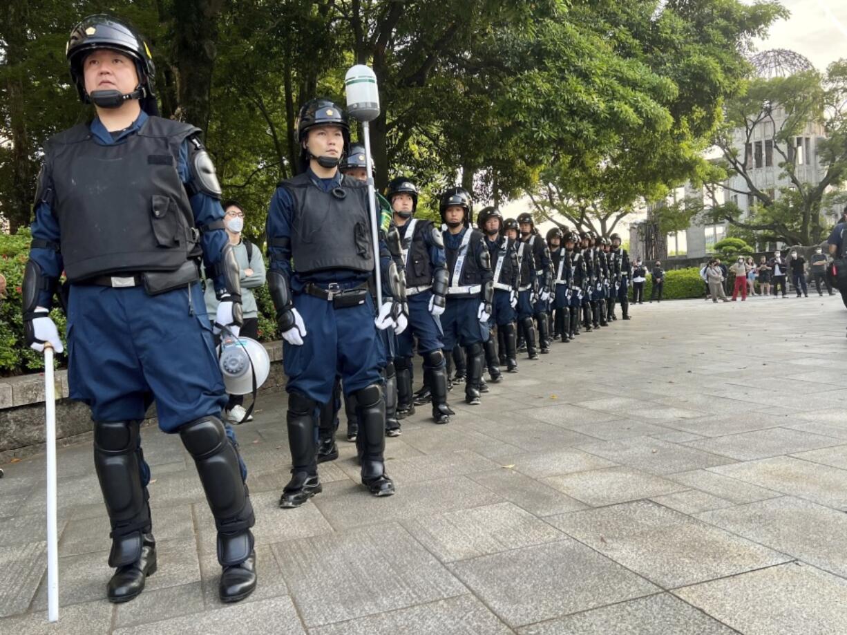 Police keep watch over a protest against the G-7 that is being held next to the Atomic Bomb Dome war memorial ahead of the group's meeting in Hiroshima, Japan, on Wednesday, May 17, 2023. The G-7 summit starts Friday.