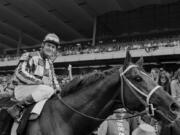 FILE - Jockey Ron Turcotte walks Secretariat towards the winners circle after they captured the Triple Crown by winning the Belmont Stakes before a crowd of 70,000 fans at Belmont Park in Elmont, N.Y., June 9, 1973.