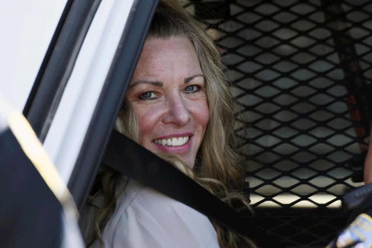 FILE - Lori Vallow Daybell sits in a police car after a hearing at the Fremont County Courthouse in St. Anthony, Idaho, on Aug. 16, 2022. The sister of Tammy Daybell, who was killed in what prosecutors say was a doomsday-focused plot, told jurors Friday, April 28, 2023, that her sister's funeral was held so quickly that some family members couldn't attend. The testimony came in the triple murder trial of Vallow Daybell, who is accused along with Chad Daybell in Tammy's death and the deaths of Vallow Daybell's two youngest children.