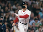 Boston Red Sox's Masataka Yoshida watches the flight of his RBI double in the fifth inning of a baseball game against the Seattle Mariners at Fenway Park, Tuesday, May 16, 2023, in Boston.