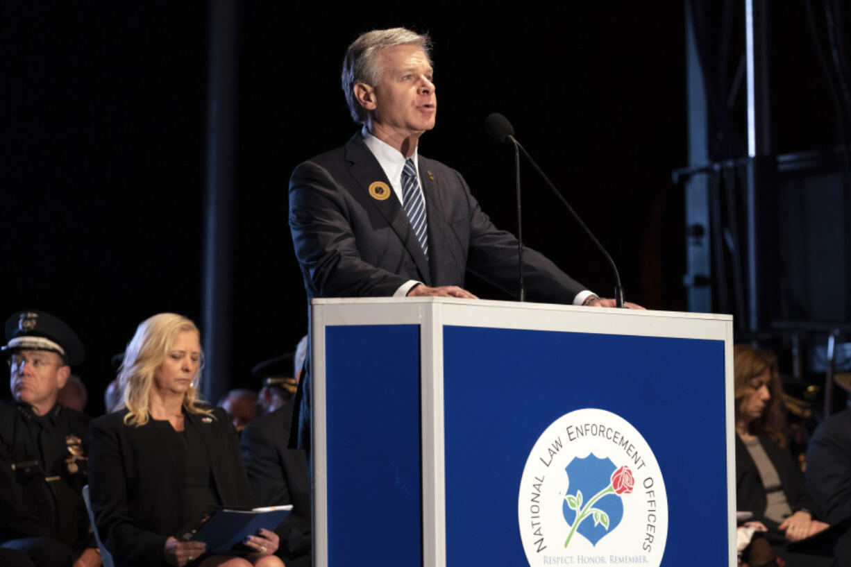 FBI Director Christopher Wray speaks during the 35th Annual Candlelight Vigil to honor the law enforcement officers who lost their lives in 2022, during the National Police Week at the National Mall in Washington, Saturday, May 13, 2023.