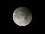 FILE - A penumbral lunar eclipse is seen from Lahore, Pakistan, on Feb. 11, 2017. Late Friday, May 5, 2023, into Saturday, May 6, stargazers in Asia and Australia were treated to a penumbral lunar eclipse, where the moon got only a bit darker and did not exhibit the hallmarks of a total lunar eclipse. (AP Photo/K.M.