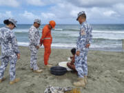 In this handout photo provided by the Philippine Coast Guard, Philippine Coast Guard personnel check on a fisherman while conducting patrol along shore lines in Ilocos Norte province, northern Philippines, as they prepare for the possible effects of Typhoon Mawar on Monday, May 29, 2023. Philippine officials began evacuating thousands of villagers, shut down schools and offices and imposed a no-sail ban Monday as Typhoon Mawar approached the country's northern provinces a week after battering the U.S. territory of Guam.