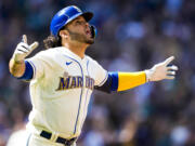 Seattle Mariners' Eugenio Suarez reacts as he runs the bases after hitting a three-run walk-off home run to win the game against the Pittsburgh Pirates during the tenth inning of a baseball game, Sunday, May 28, 2023, in Seattle. The Mariners won 6-3.