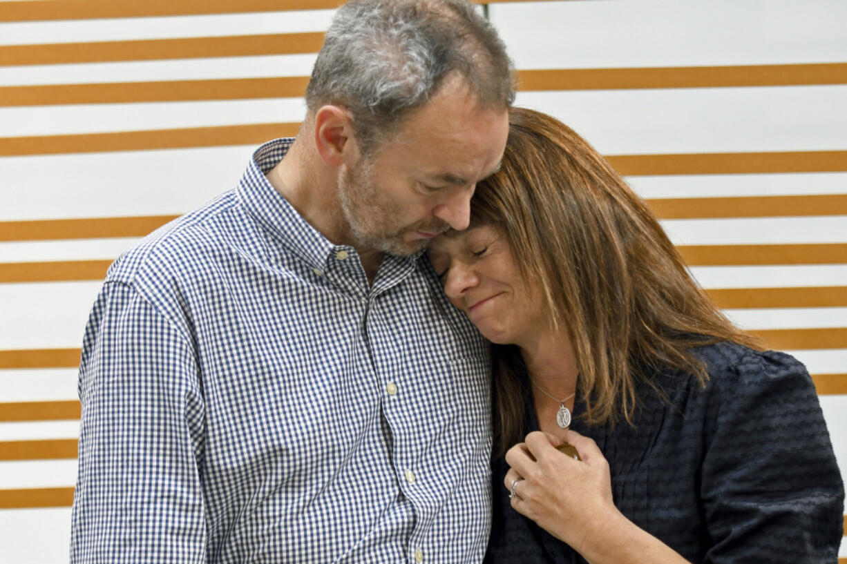 FILE - Simon and Sally Glass comfort each other during an emotional news conference in Denver on Tuesday, Sept. 13, 2022. They are calling for accountability after police shot and killed their 22-year-old son, Christian Glass, after he called 911 for roadside assistance in the Colorado mountain town of Silver Plume in June. The Glasses say their son was having a mental health episode and police needlessly escalated the situation.