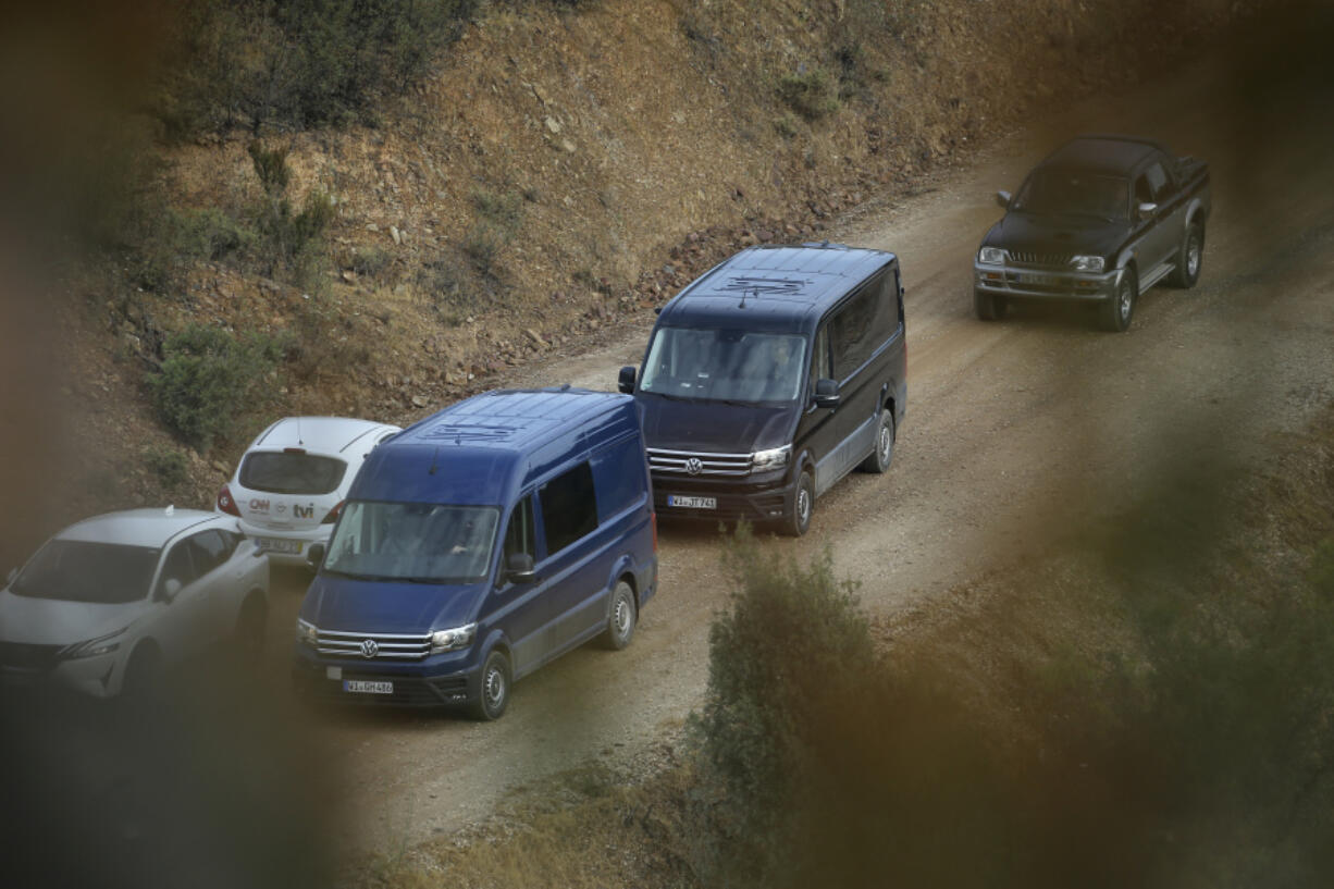 Vans with German number plates arrive at a police operations centre near Barragem do Arade, Portugal, Tuesday May 23, 2023. Portuguese police said they will resume searching for Madeleine McCann, the British toddler who disappeared in the country's Algarve region in 2007, in the next few days. Portugal's Judicial Police released a statement confirming local media reports that they would conduct the search at the request of the German authorities and in the presence of British officials.