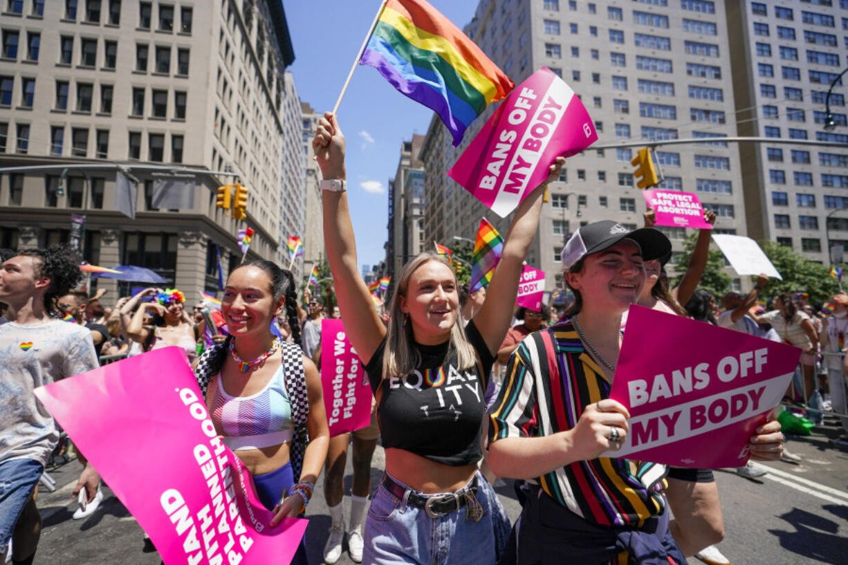 FILE - Revelers with Planned Parenthood march down Fifth Avenue during the annual NYC Pride March, on June 26, 2022, in New York. Organizers of Pride festivals and parades in conservative states are under increasing pressure to censor their events or ban drag performances. That's making it challenging to hold events that celebrate lesbian, gay, bisexual, transgender, and queer identity without running afoul of the laws.