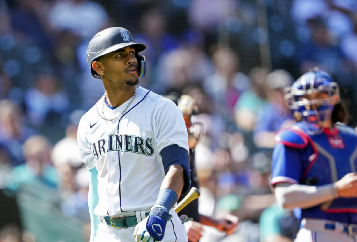 Seattle Mariners' Julio Rodriguez looks on after striking out against the Texas Rangers during the ninth inning of a baseball game Wednesday, May 10, 2023, in Seattle. The Rangers won 4-3.