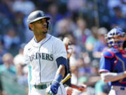 Seattle Mariners' Julio Rodriguez looks on after striking out against the Texas Rangers during the ninth inning of a baseball game Wednesday, May 10, 2023, in Seattle. The Rangers won 4-3.