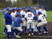 The members of the Ridgefield baseball team celebrate their 6-2 win over Mark Morris in a 2A Greater St. Helens League baseball game at the Ridgefield Outdoor Recreation Complex on Monday, May 1, 2023.