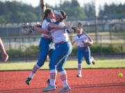 Elizabeth Peery hugs Maizy Whitlow after the final out of Ridgefield's 4-3 win over Tumwater in the semifinals of the 2A District 4 tournament, May 18 at Rec Park in Chehalis.