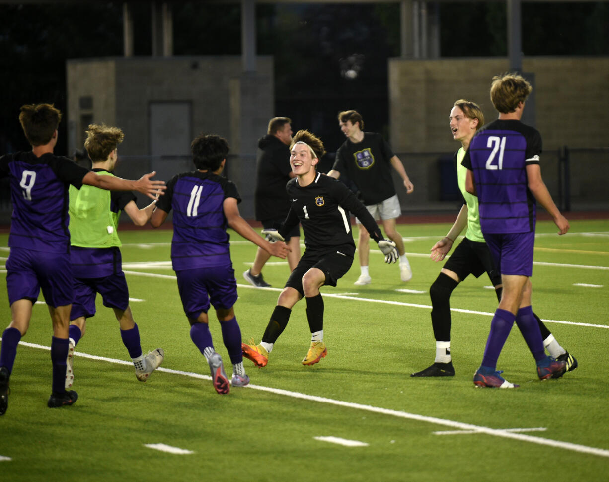 Columbia River goalkeeper Cameron Harris (1) joins his teammates in celebration after the Rapids' 2-1 win over Sehome in the Class 2A boys soccer state semifinal at Renton Memorial Stadium on Friday, May 26, 2023.