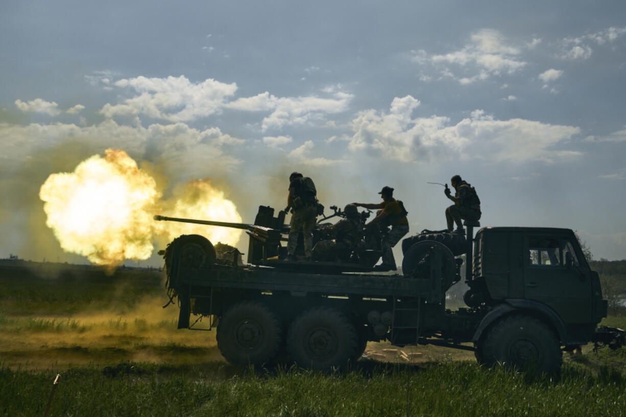 FILE - Ukrainian soldiers fire a cannon near Bakhmut, an eastern city where fierce battles against Russian forces have been taking place, in the Donetsk region, Ukraine, May 15, 2023. For months, Western allies have shipped billions of dollars worth of weapons systems and ammunition to Ukraine with an urgency to get the supplies to Kyiv in time for an anticipated spring counteroffensive. Now summer is just weeks away. While Russia and Ukraine are focused on an intense battle for Bakhmut, the Ukrainian spring offensive has yet to begin.