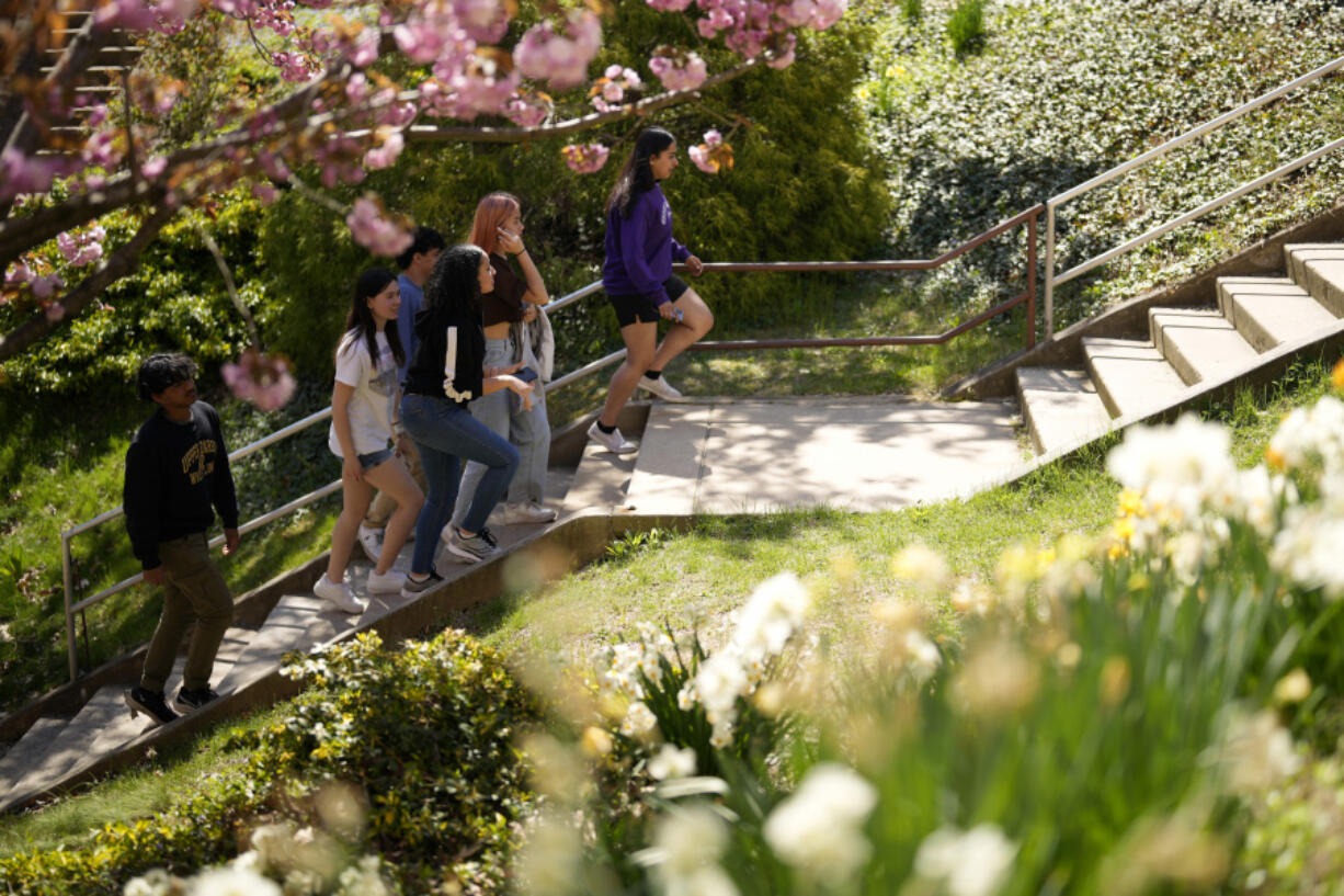 Upper Darby High School students Tanveer Kaur, from right, Joey Ngo, Fatima Afrani, Rayan Hansali, Elise Olmstead and Ata Ollah walk through the campus courtyard, Wednesday, April 12, 2023, in Drexel Hill, Pa.