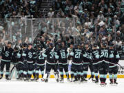 Fans cheer as the Seattle Kraken celebrate a 6-3 win over the Dallas Stars in Game 6 of an NHL hockey Stanley Cup second-round playoff series, Saturday, May 13, 2023, in Seattle.