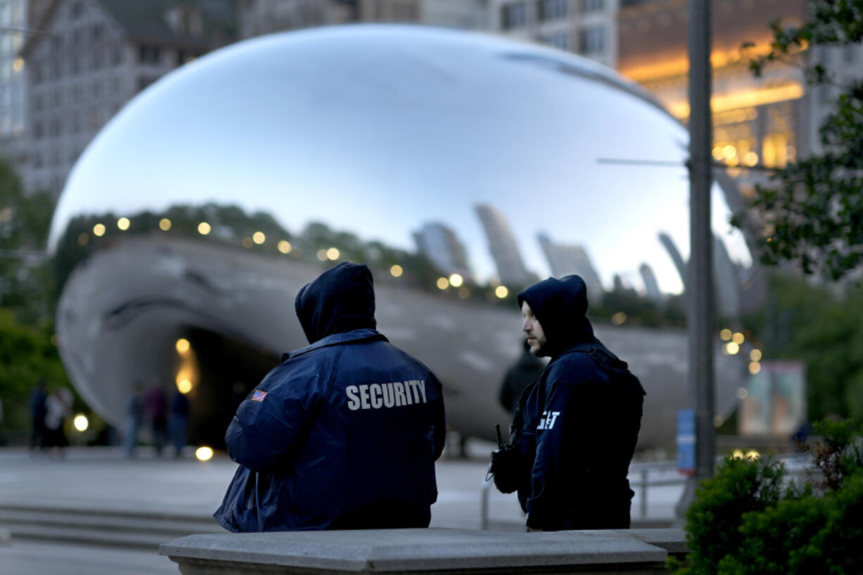 *Private security personnel patrol the area around Anish Kapoor's stainless steel sculpture Cloud Gate, also known as "The Bean," in Chicago's Millennium Park Thursday, May 25, 2023. Chicago is heading into the Memorial Day weekend hoping to head off violence that tends to surge with rising temperatures of summer. Even the state of Illinois is assisting by sending in what it's called "peacekeepers" in an attempt to deescalate violent situations.