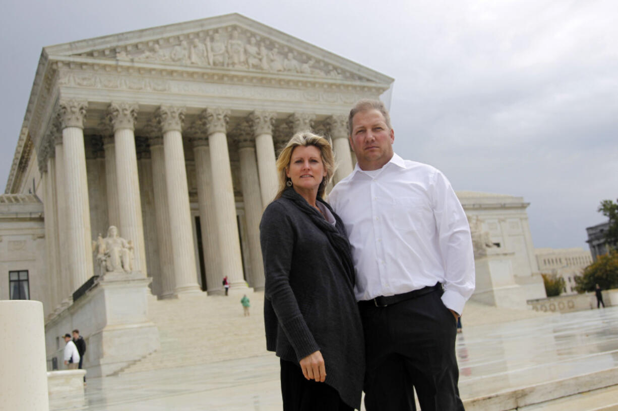 FILE - Michael and Chantell Sackett of Priest Lake, Idaho, pose for a photo in front of the Supreme Court in Washington on Oct. 14, 2011. The Supreme Court said Monday, May 25, 2023, said it will consider reining in federal regulation of private property under the nation's main anti-water pollution law, the Clean Water Act. The justices agreed to hear a business-backed appeal from Chantell and Michael Sackett, who have wanted to build a home close to Priest Lake in Idaho for 15 years and won an earlier round in their legal fight at the Supreme Court. (AP Photo/Haraz N.