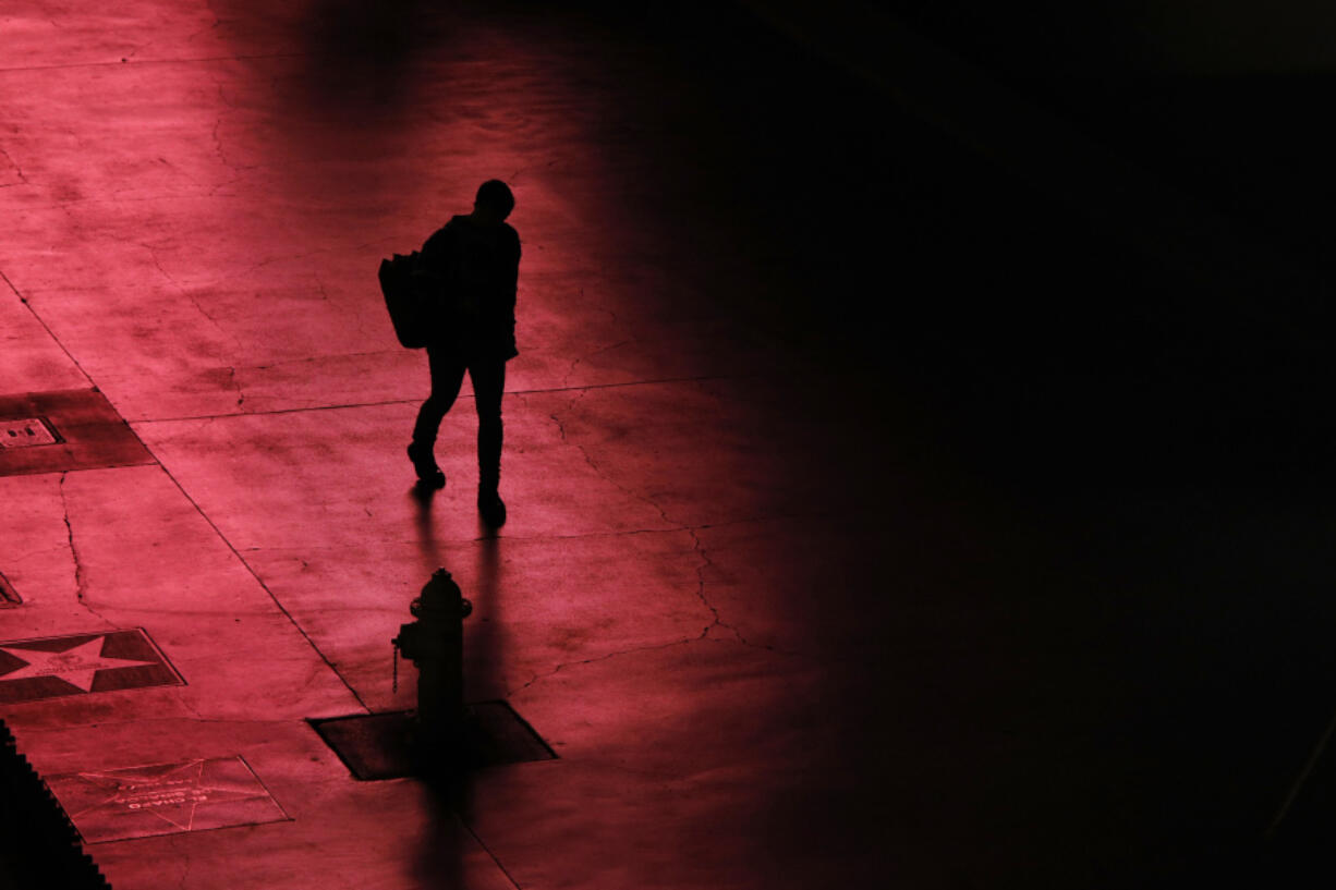 A person walks along the Las Vegas Strip devoid of the usual crowds on March 18, 2020, after casinos were ordered to shut down due to the coronavirus.