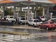 Motorists wait in a long line to purchase fuel at a Circle K/76 gas station at the corner of Marine Corps Drive and Ypao Road in Tamuning, Guam, Thursday, May 25, 2023, in the aftermath of Typhoon Mawar.