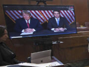 FILE - Former President Donald Trump, left on screen, and his attorney, Todd Blanche, right on screen, appear by video before a hearing begins in Manhattan criminal court, in New York, May 23, 2023. Trump speaks about his legal woes in a way that would make most defense attorneys wince. The former president has never hesitated to offer his opinion or joust with his antagonists. But legal experts say Trump's freewheeling speaking style could give prosecutors additional ammunition to use against him in court.