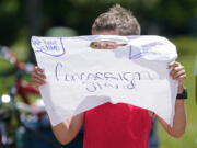 File - Andrew Addison holds up a sign advertising that he takes Venmo for payment at his corner drink stand, Monday, May 30, 2022, in Nolensville, Tenn. Venmo will officially allow teenagers to open an account with their parents' permission, the company said Monday, expanding the popular social payments app to a demographic that is likely to embrace it almost immediately.