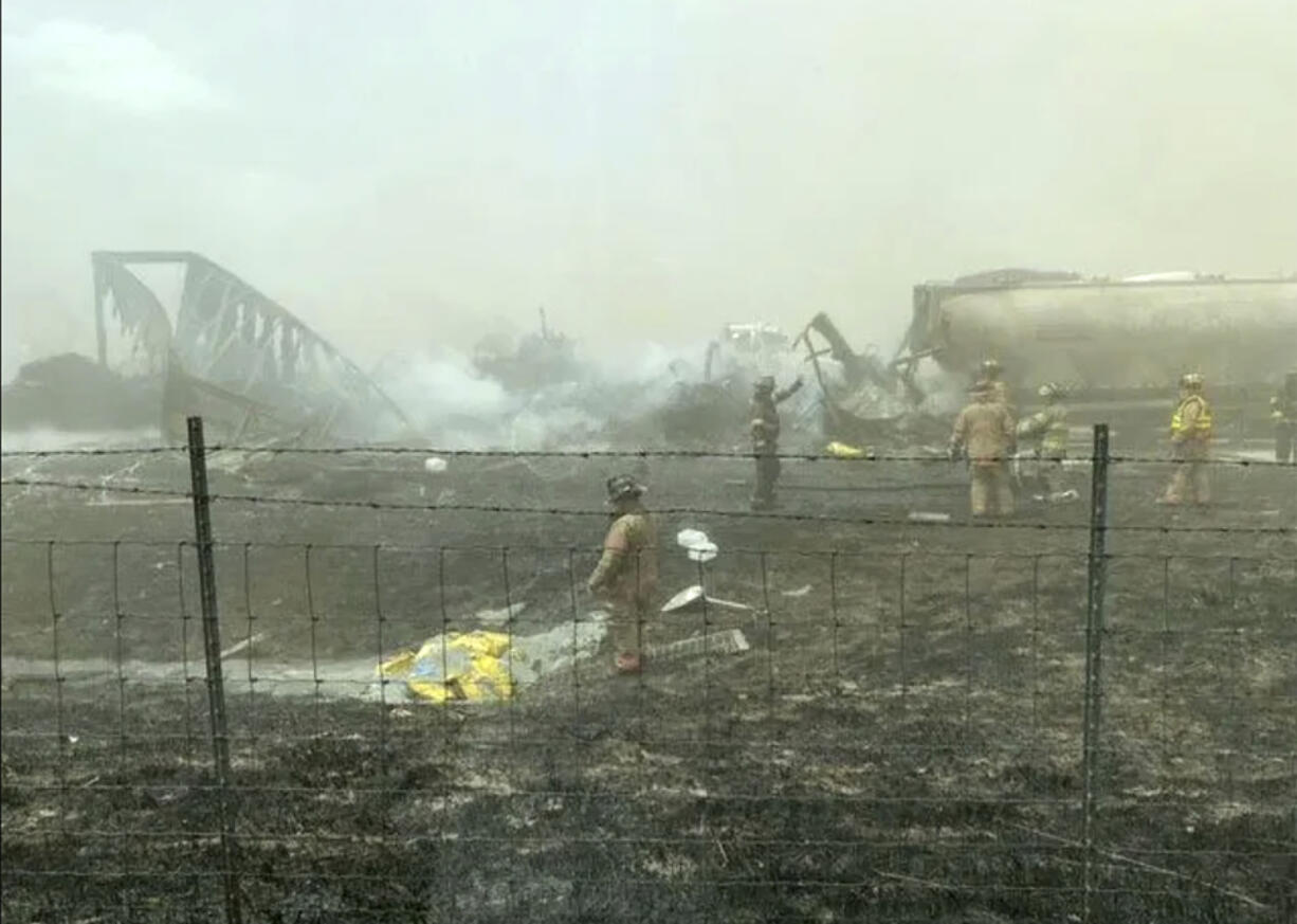 First responders work the scene of a crash involving at least 20 vehicles that shut down a highway in Illinois, Monday, May 1, 2023. Illinois State Police say a windstorm that kicked up clouds of dust in south-central Illinois has led to numerous crashes and multiple fatalities on Interstate 55.