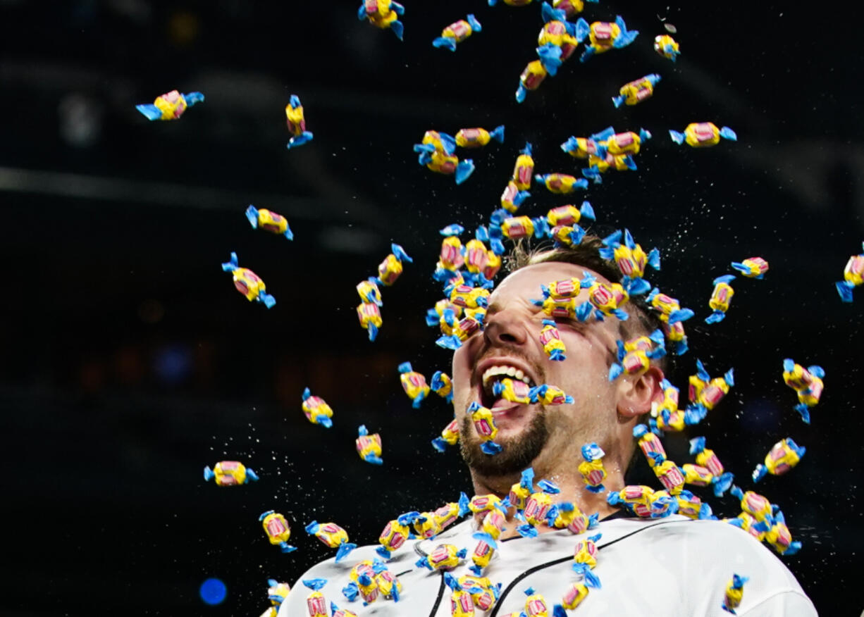 Seattle Mariners' Cal Raleigh smiles as a teammate throws bubble gum at him during an interview after Raleigh hit a single to drive in the winning run against the New York Yankees during the 10th inning of a baseball game Wednesday, May 31, 2023, in Seattle.